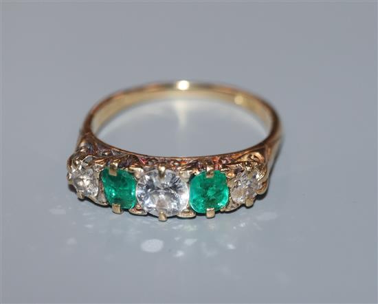 An 18ct, emerald and diamond five-stone half hoop dress ring, size M/N.